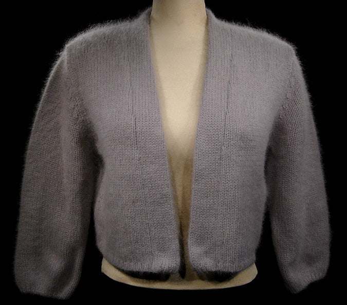 Woman's soft gray angora shrug cardigan sweater with open front and three-quarter sleeves