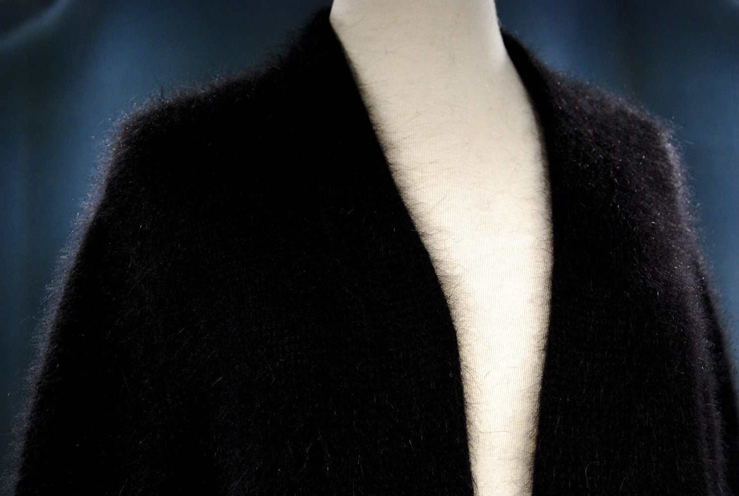 Black woman's angora shrug cardigan sweater with open front and three-quarter sleeves on mannequin