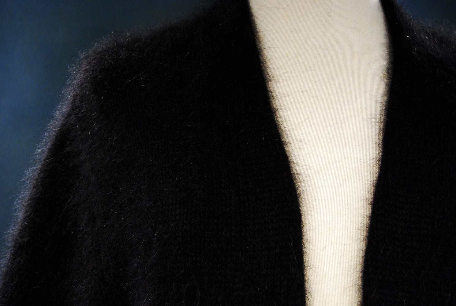Black woman's angora shrug cardigan sweater with open-front and three-quarter sleeves on mannequin