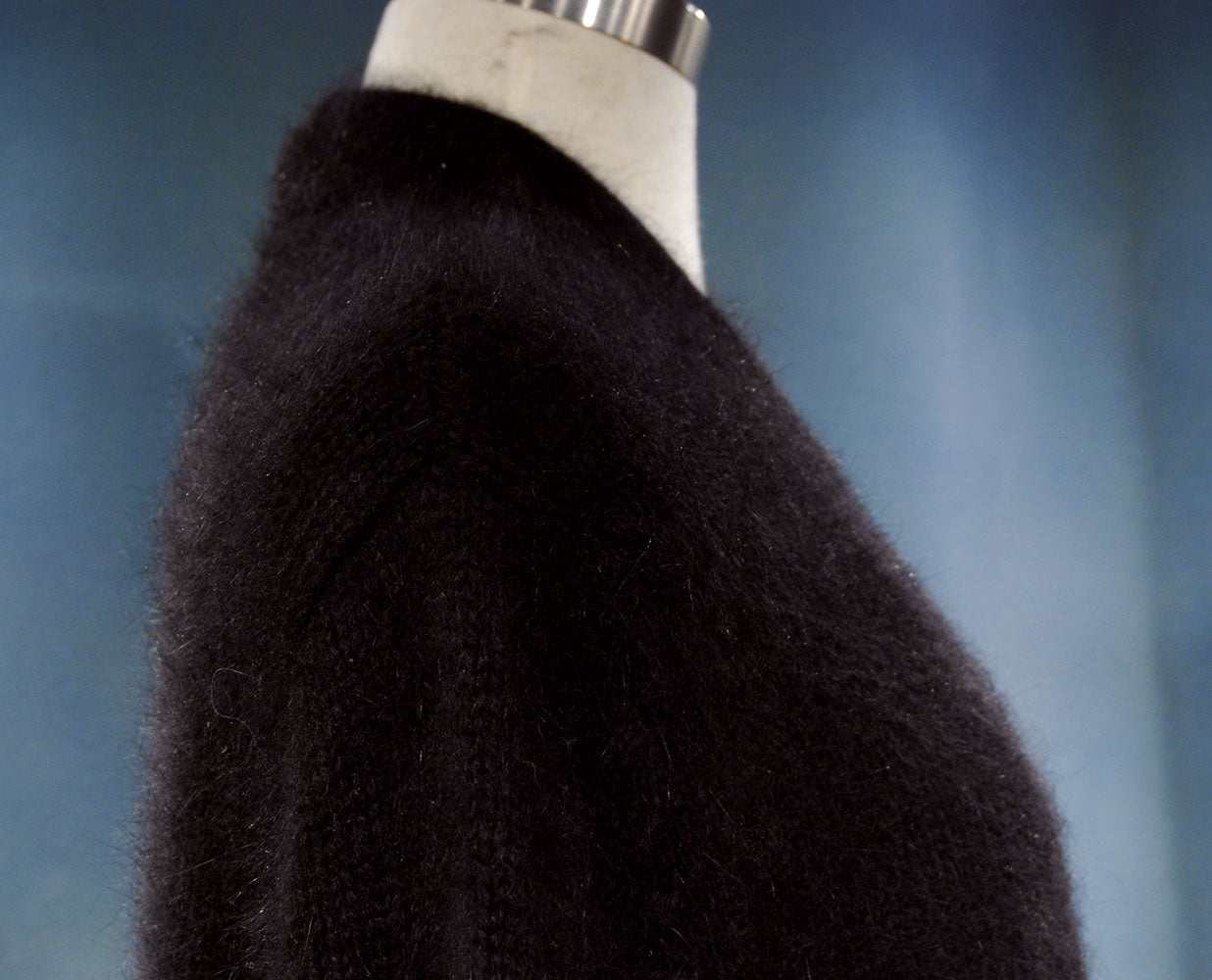 Black woman's angora shrug cardigan sweater with open front and three-quarter sleeves on mannequin