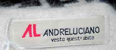 Close-up of Andre Luciano label on woman's fancy white angora sweater with embroidered trim