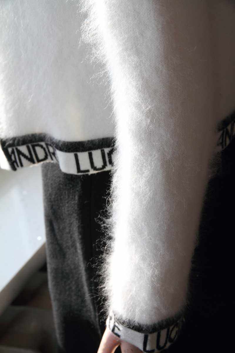 Close-up of woman's fancy white angora open-front sweater with embroidered Andre Luciano trim in size X-Small.
