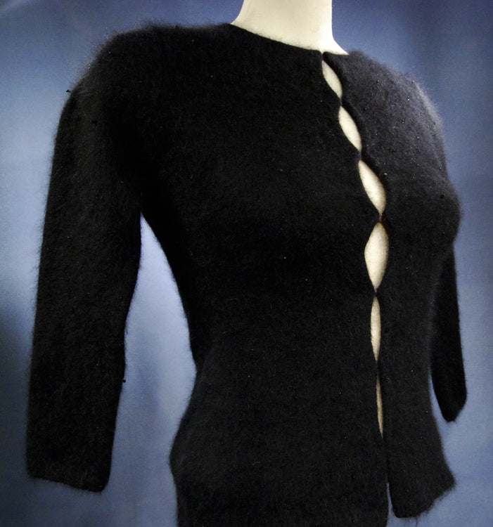 Woman's black angora cardigan sweater with unique hook and loop closures on mannequin