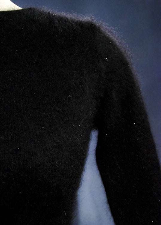 Woman's black angora cardigan sweater with long sleeves and soft texture