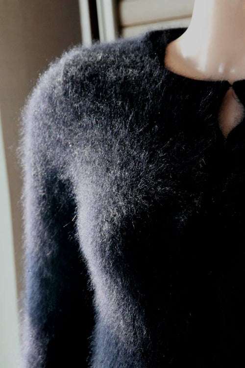 Woman's black angora cardigan sweater with soft fuzzy texture and unique hook and loop closures in size XX-Small
