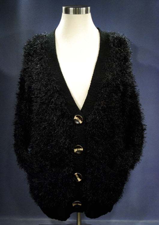 Black woman's eyelash cardigan sweater with long fuzzy acrylic fibers and four buttons on mannequin
