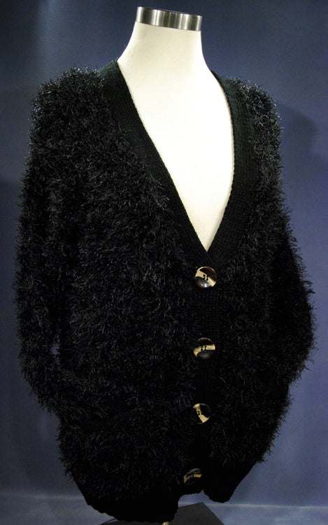 Black woman's eyelash cardigan sweater with long fuzzy acrylic fibers and four buttons