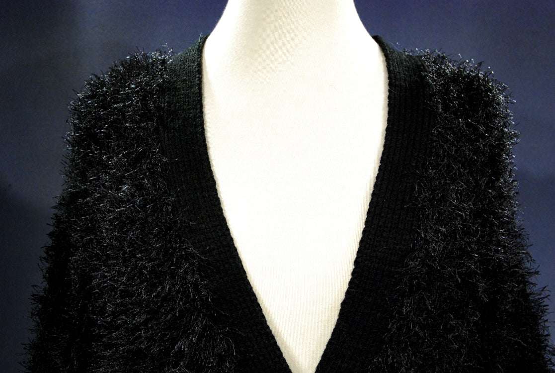 Black woman's eyelash cardigan sweater with long fuzzy acrylic fibers and four buttons, front pockets, X-Small/Small size