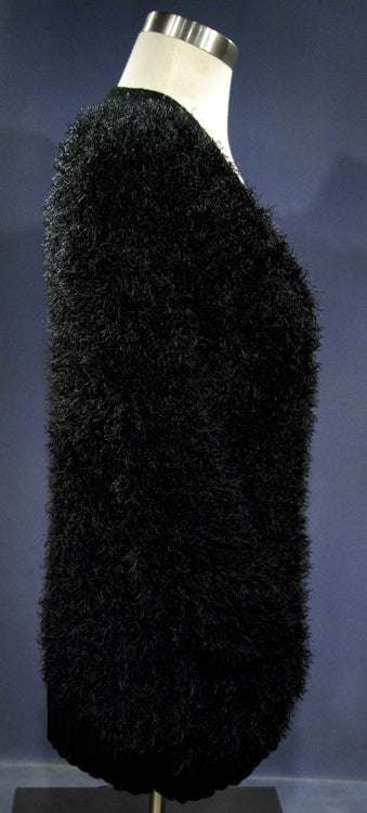 Black woman's eyelash cardigan sweater with long fuzzy faux rabbit fur fibers and front pockets on mannequin