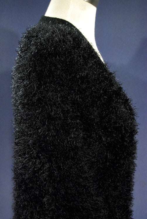 Black fuzzy long-fiber woman’s eyelash cardigan sweater with front pockets and four buttons