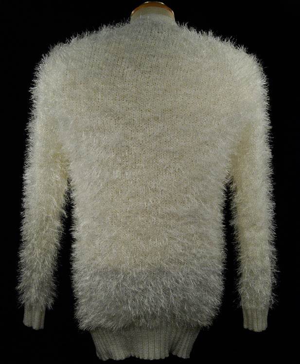 Woman's eyelash cardigan sweater with long fuzzy acrylic fibers in light beige color shown from back