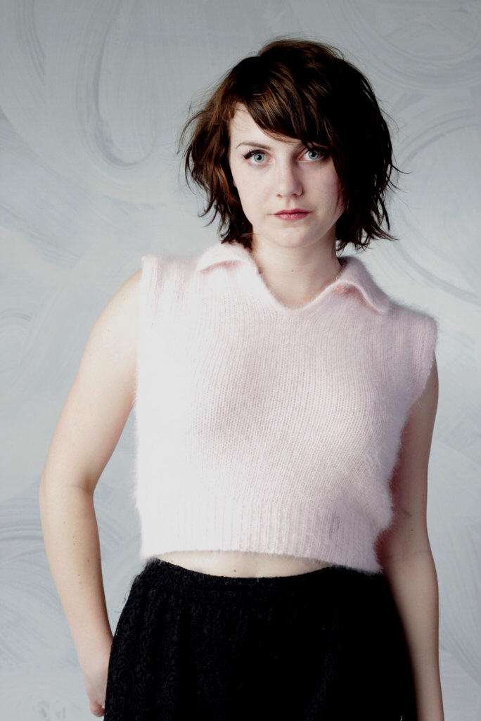 Woman wearing a pink angora cropped sleeveless polo-neck sweater by Moda Intl