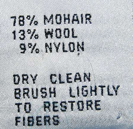 Colorful woman's mohair cardigan label showing 78% mohair, 13% wool, 9% nylon with care instructions for dry cleaning and brushing fibers.