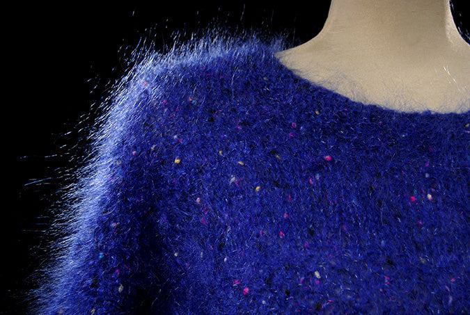Woman's blue speckled mohair V-neck sweater with red, green, yellow, and blue knit-in specks by Icelandic Design