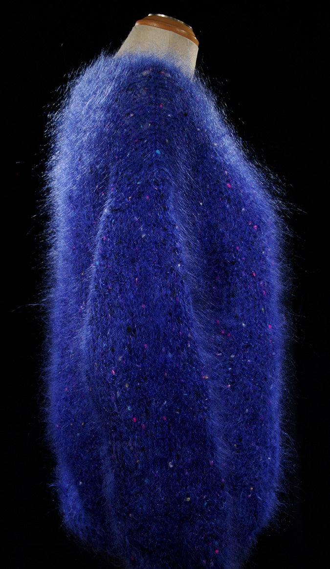 Woman's blue speckled mohair V-neck sweater with red, green, yellow, and blue specks by Icelandic Design, medium size.