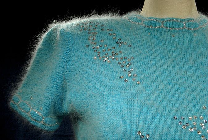 Woman's two-piece matching aqua angora sweater and skirt set with silver sequins and rhinestone embellishments