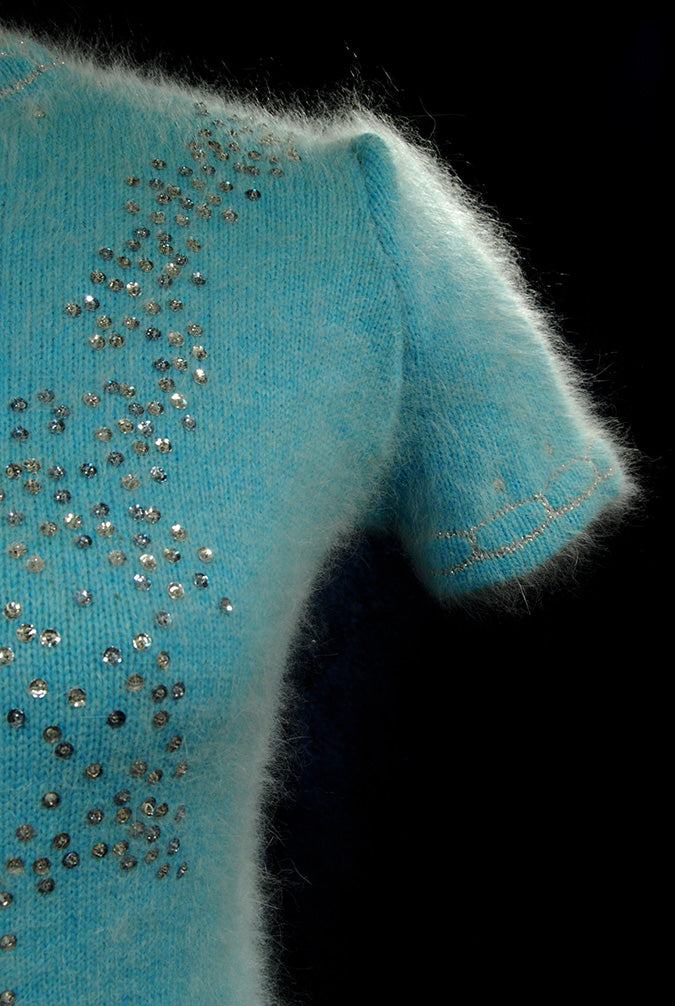 Woman's two-piece aqua angora sweaterdress with silver sequins and rhinestone embellishments