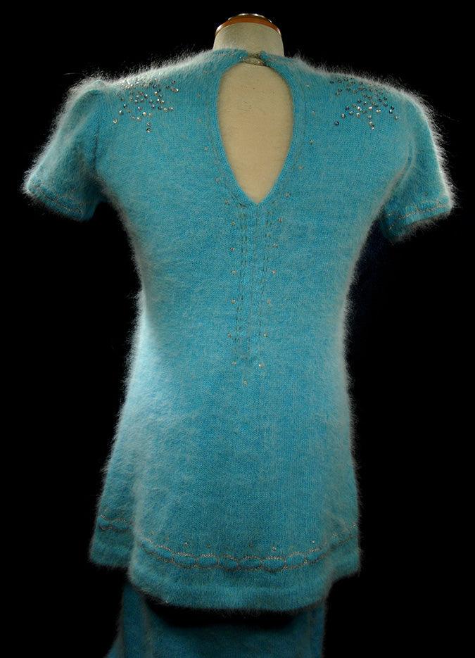 Woman's two-piece matching aqua angora sweaterdress outfit with rhinestone and sequin embellishments, keyhole back neckline, and short sleeves.