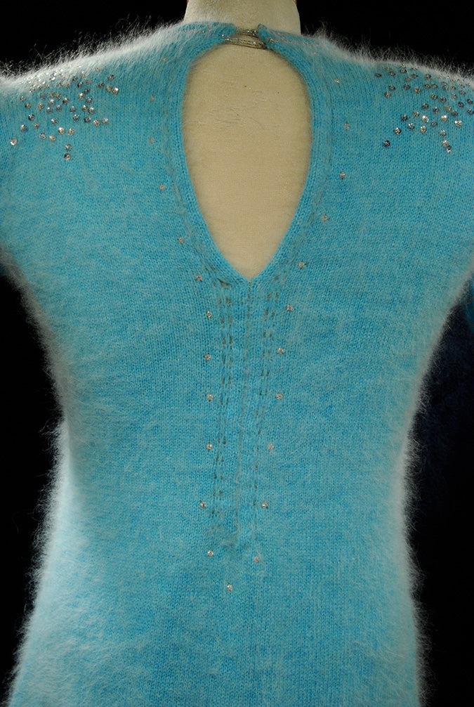 Woman's two-piece matching aqua angora sweaterdress outfit with rhinestone and sequin embellishments by Mary Farrin for Bonwit Teller.