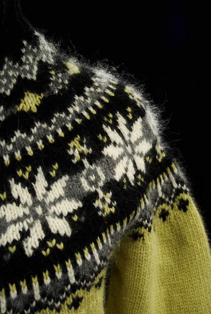 Woman's black and pale yellow angora turtleneck sweater with snowflake design and zipper front
