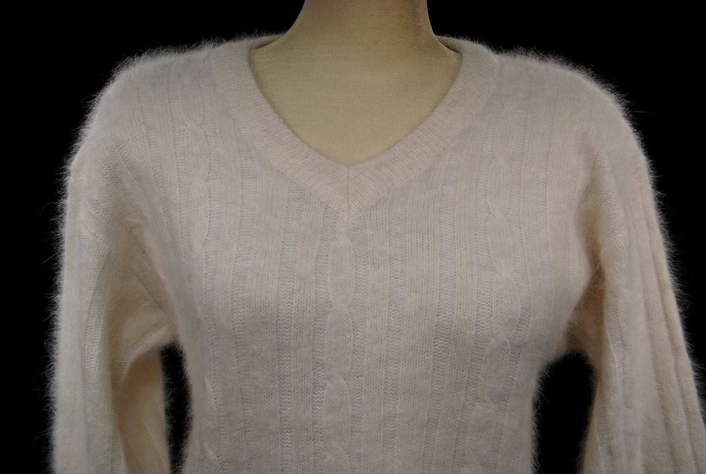 Woman's white angora rib-knit V-neck sweater in small size displayed on mannequin
