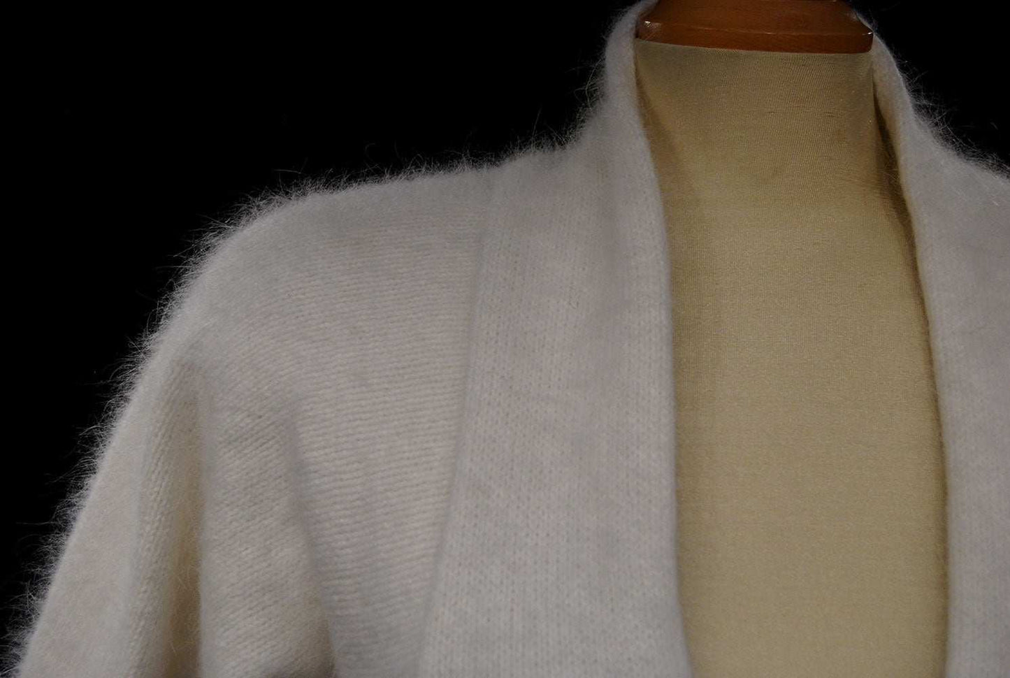 Woman's white angora open-front shrug cardigan sweater on mannequin