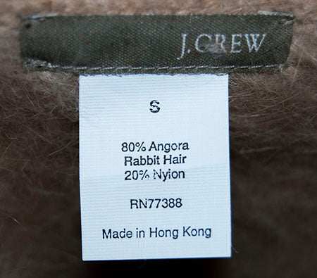 J.Crew woman's cardigan angora sweater label showing 80% angora rabbit hair and 20% nylon blend in small size