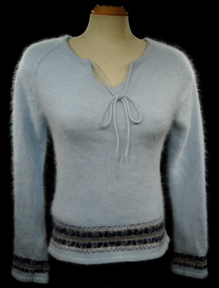 Powder blue soft angora tie-neck sweater with blue and grey stripes and long sleeves on mannequin