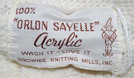 Close-up of Orlon Sayelle acrylic label on women's retro cable-knit tennis sweater