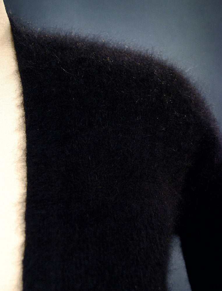 Close-up of woman's black angora wool cardigan sweater by Victoria's Secret