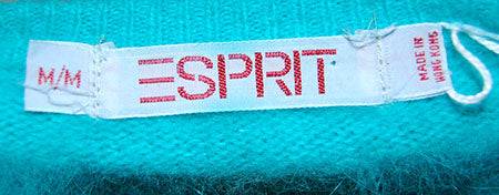 Teal-green angora sleeveless sweater vest by Esprit with M/M size tag on turquoise-aqua fabric