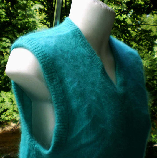 Teal-green angora sleeveless sweater vest on mannequin in outdoor setting