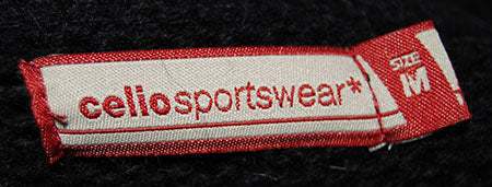 Close-up of a red and white Celio Sportswear size M label on a men's soft black turtleneck lambswool angora sweater