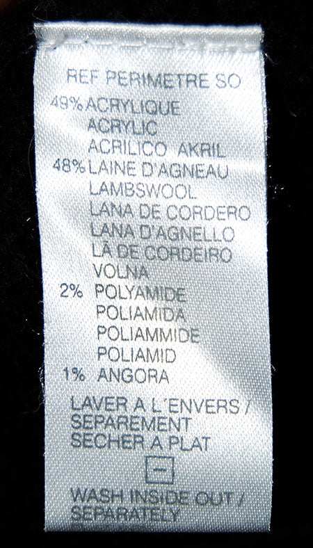 Care label of men's soft black turtleneck lambswool and angora sweater with fiber composition and washing instructions