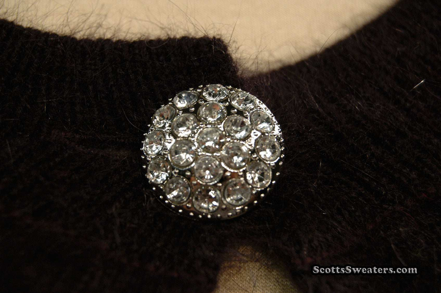 Close-up of jeweled rhinestone button on Woman's Angora Shrug cardigan sweater by Express