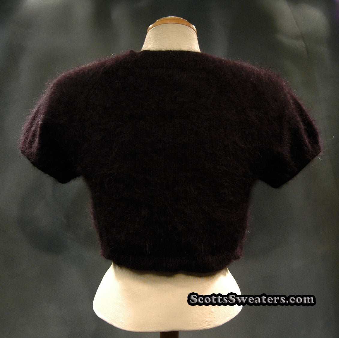 Dark brown woman's angora shrug cardigan sweater by Express displayed on a mannequin.