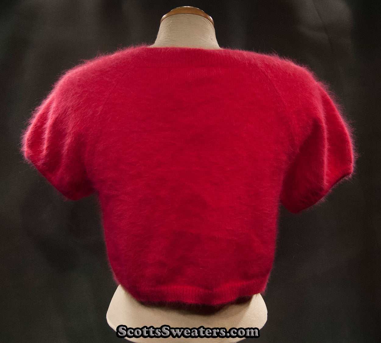 Woman's red angora shrug cardigan sweater with short sleeves on mannequin
