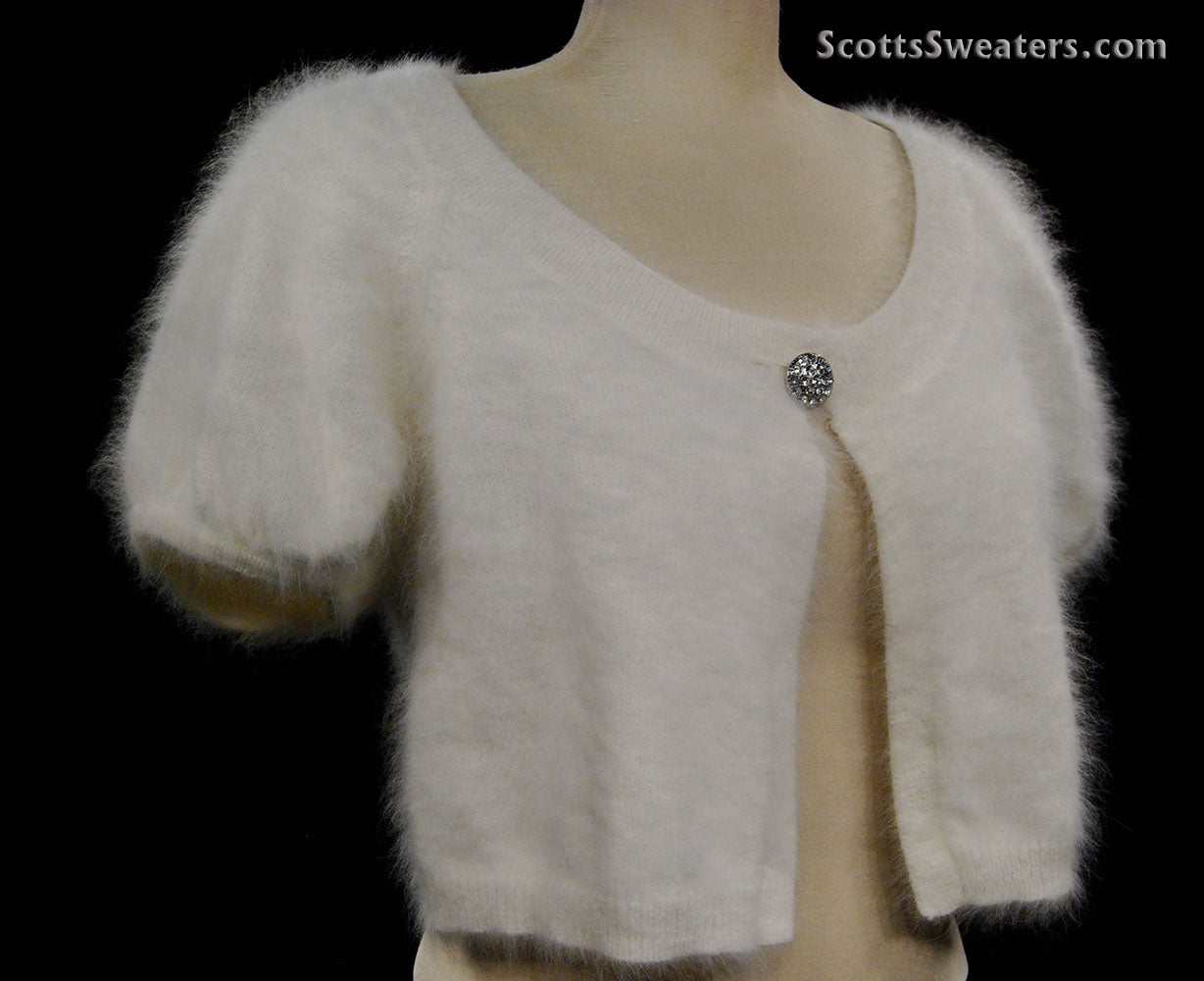 Woman's angora shrug cardigan with jeweled rhinestone button by Express on mannequin