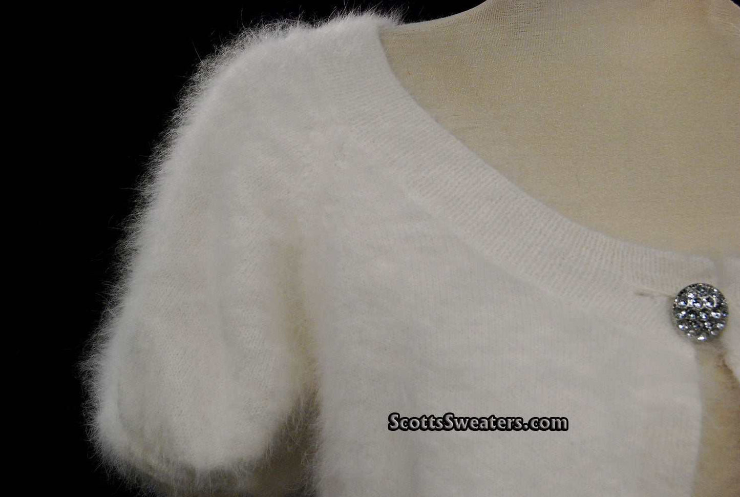 White woman's angora shrug cardigan sweater with jeweled rhinestone button by Express