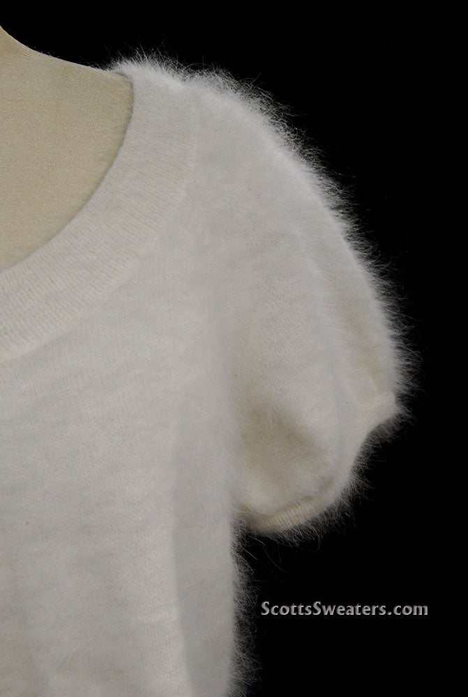 White woman's angora shrug with jeweled rhinestone button by Express on mannequin