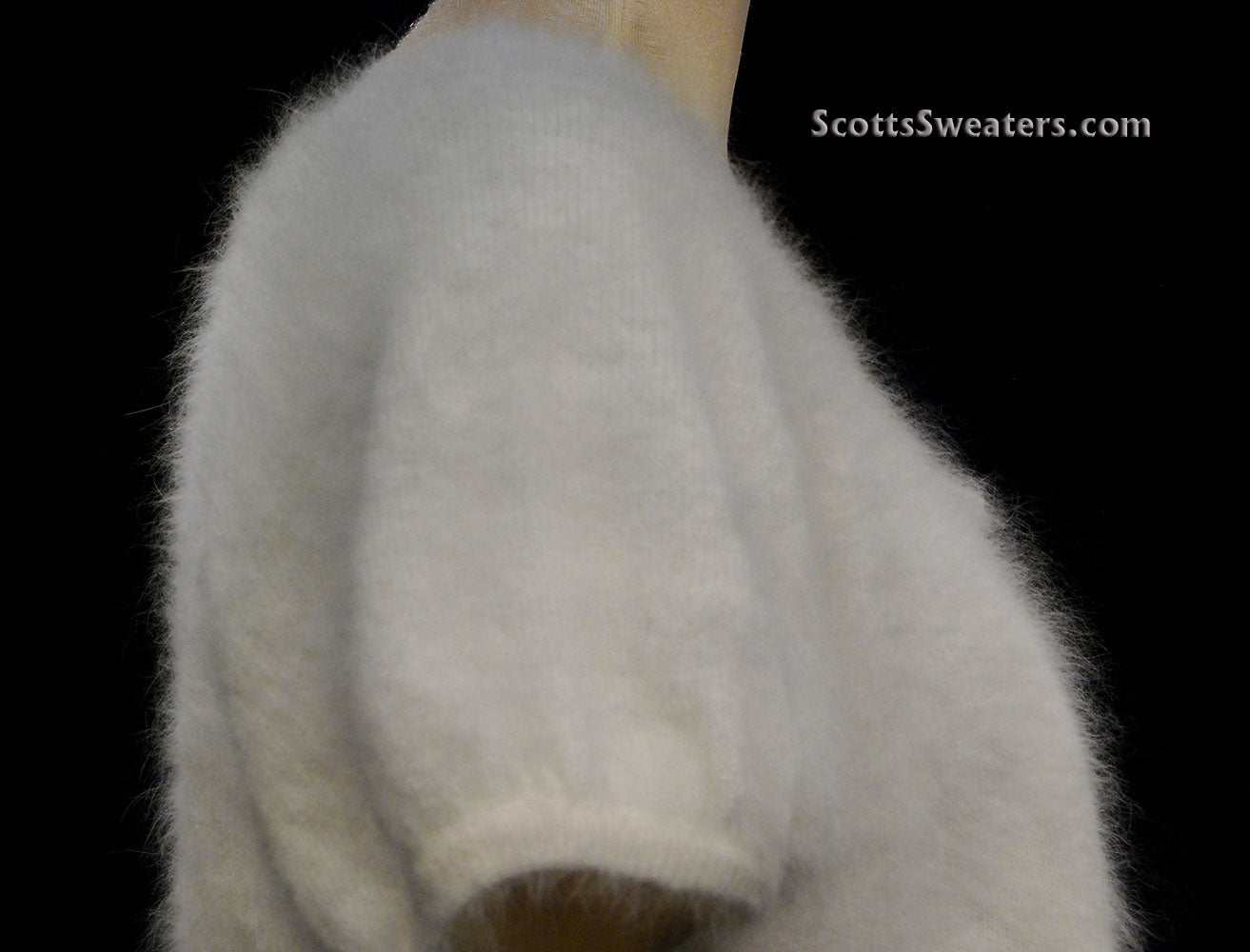 White woman's angora shrug cardigan sweater with jeweled rhinestone button by Express
