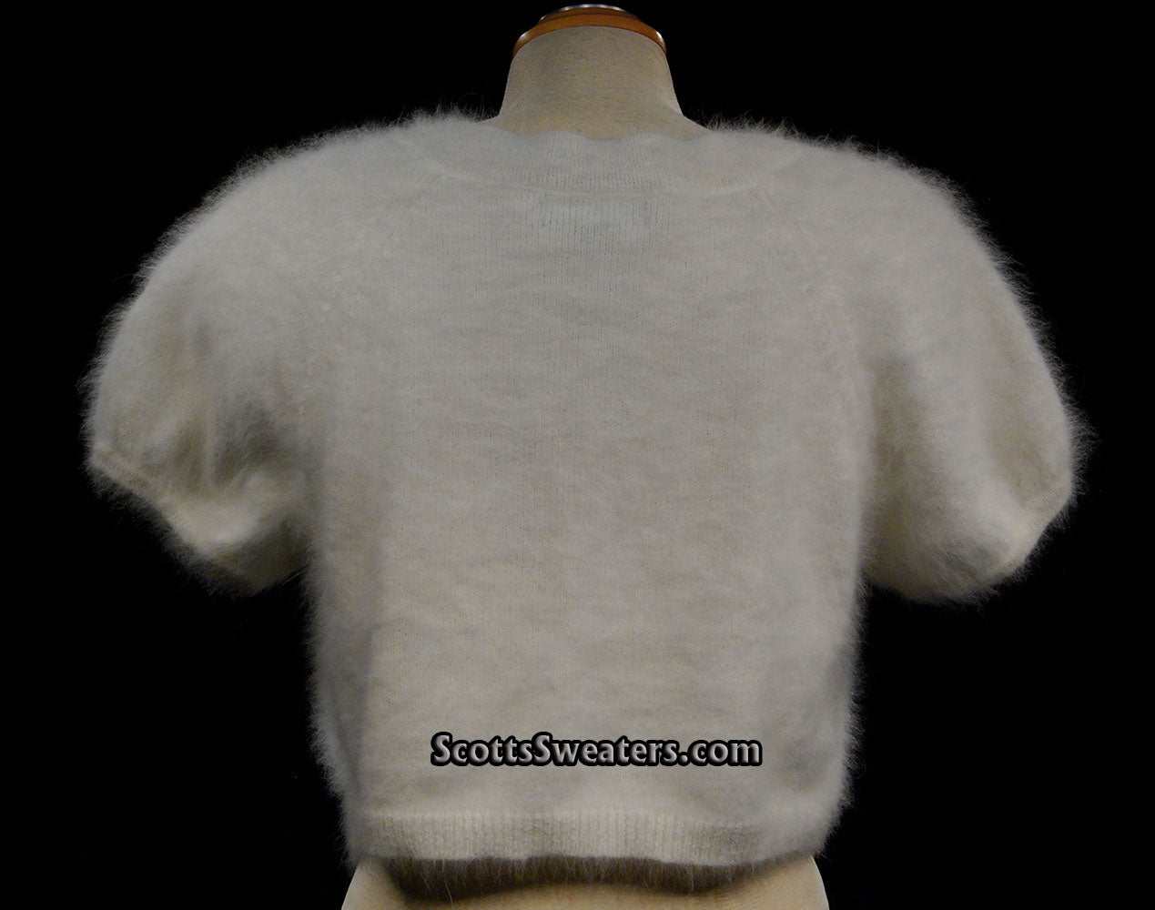 White woman's angora shrug cardigan sweater with short sleeves and soft fluffy texture