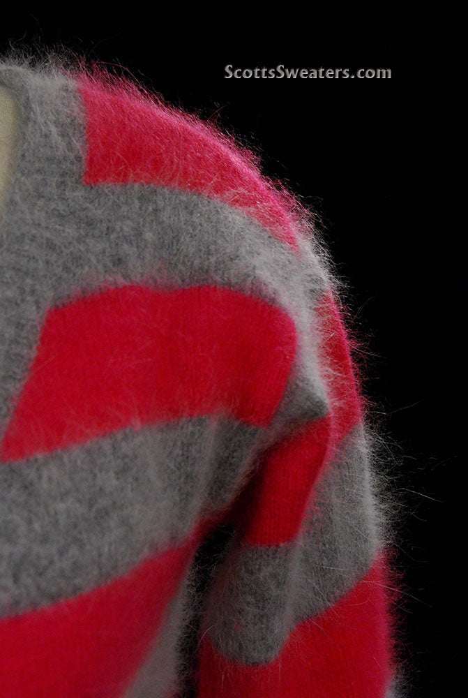 Close-up of a woman's pink and grey striped angora cardigan sweater by MODA International, soft and fuzzy texture.