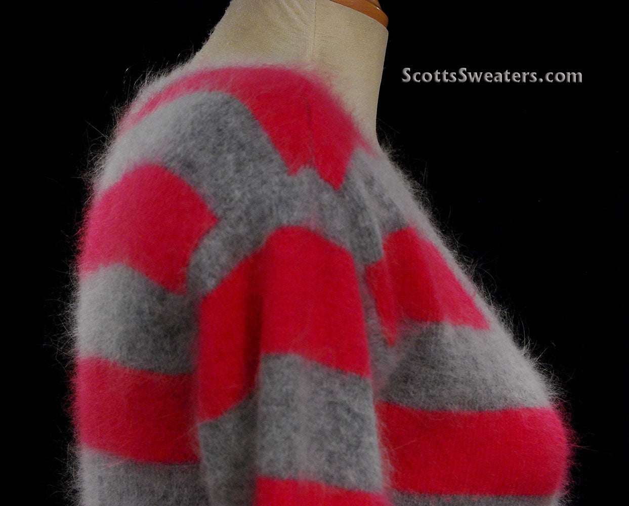 Woman's pink and grey striped angora cardigan sweater by MODA International displayed on a mannequin