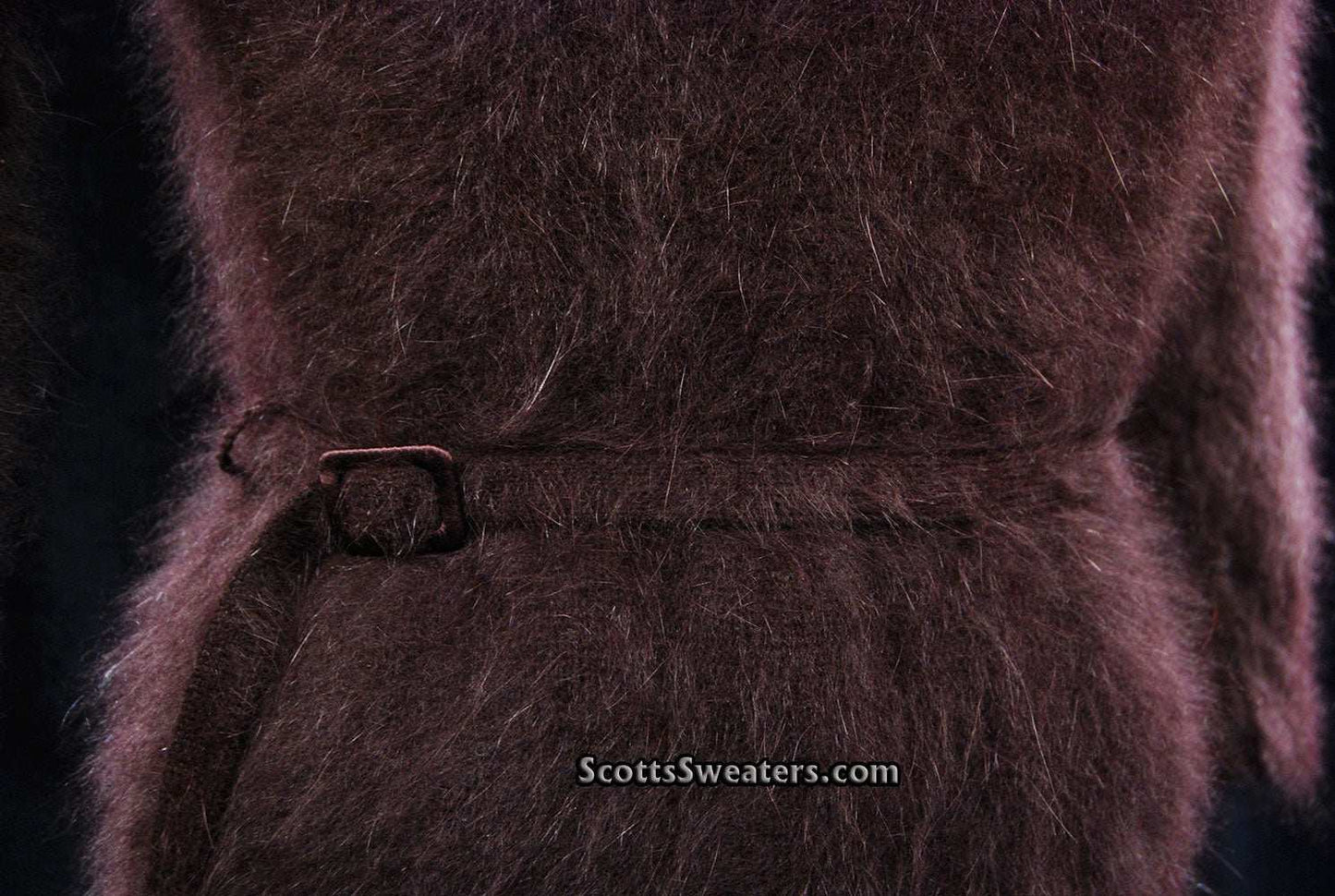 Close-up of luxurious brown angora shawl-collar sweater with narrow waist belt and soft fluffy texture by Monsoon