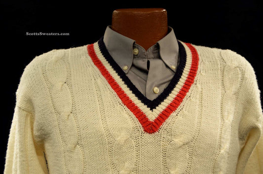 Classic V-neck pullover cable-knit tennis sweater in cream with red and navy trim on collar