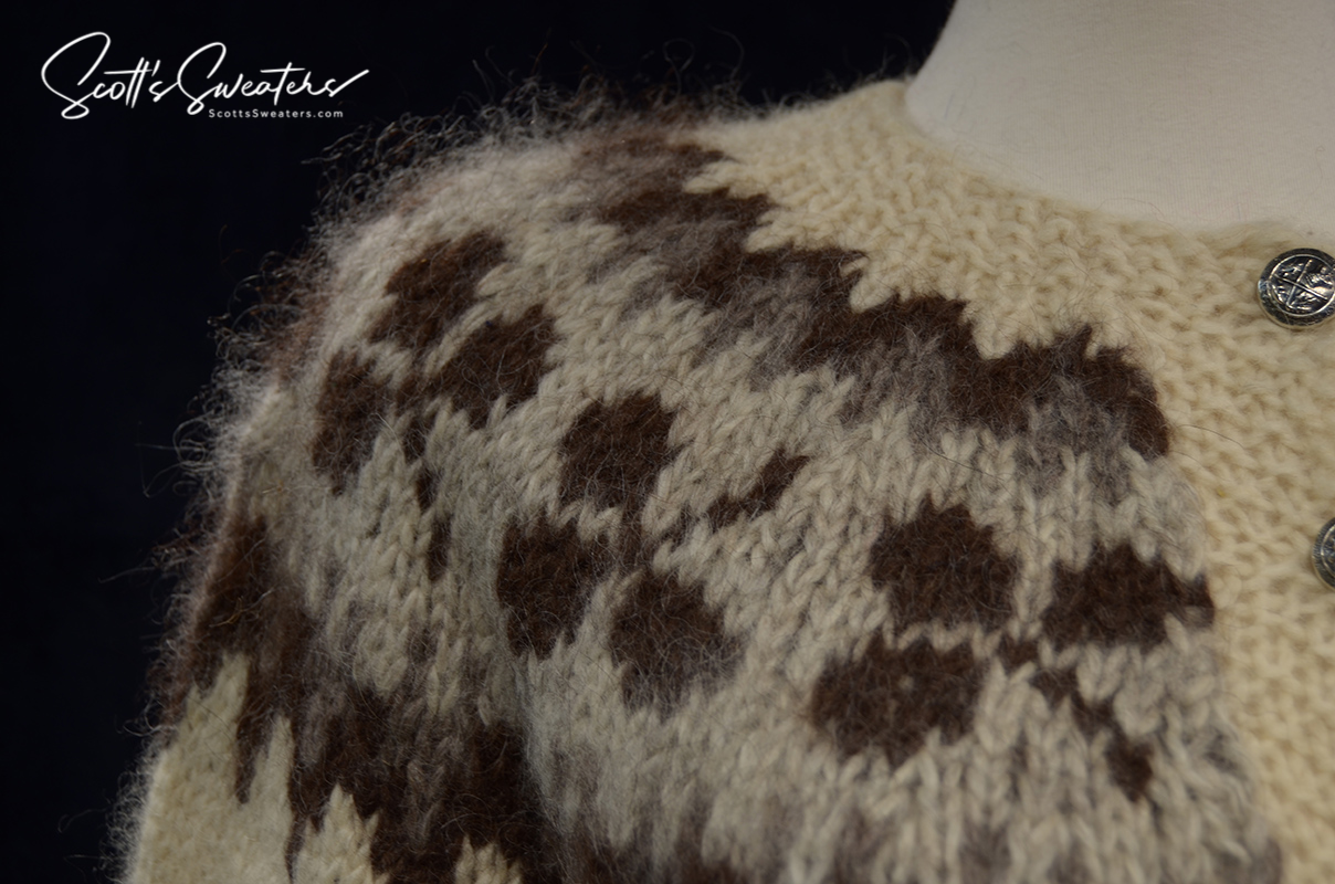 Close-up of natural brown and cream Icelandic wool cardigan sweater with traditional pattern and metal buttons for women medium size