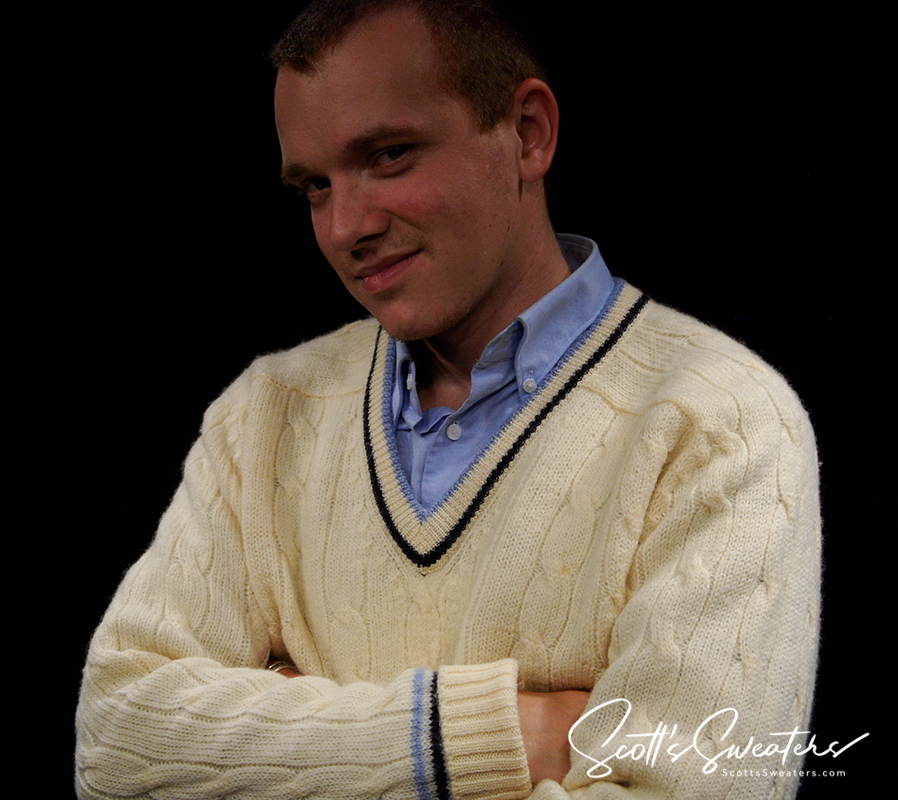 Man wearing Retro Classic Ivory Wool cable-knit tennis sweater with navy and French blue striped trim over blue shirt