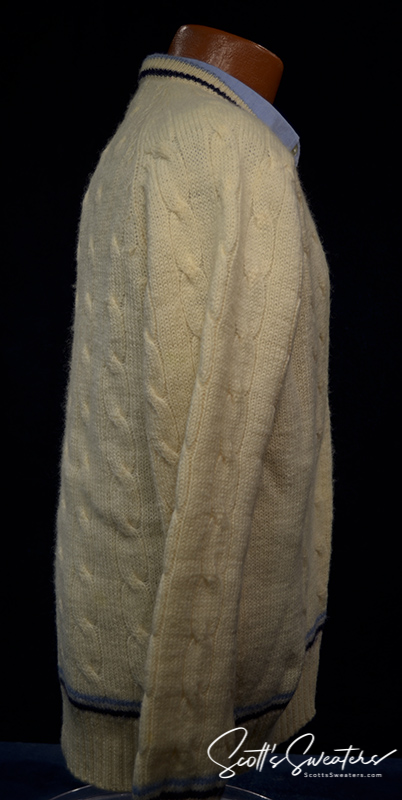 Retro classic ivory wool cable-knit tennis sweater with navy and French blue striped trim on neck, cuffs, and waist.