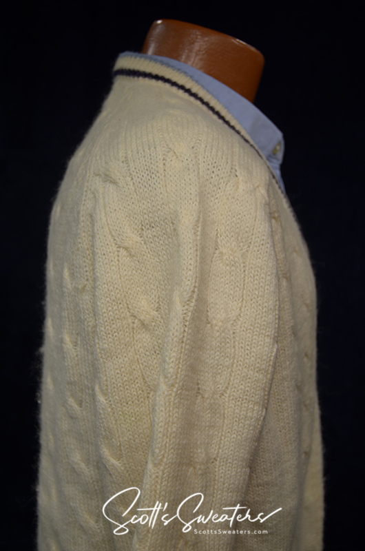 Retro classic ivory wool cable-knit tennis sweater with navy and French blue striped trim on neck, cuffs, and waist.